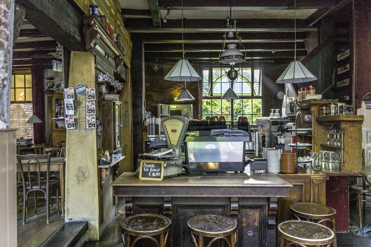 Wooden stools surrounding a table in a small coffee shop